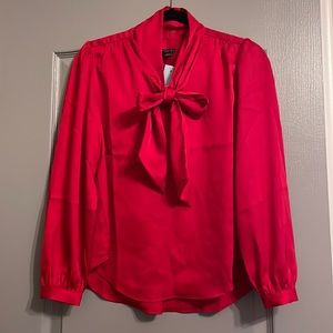 Red long sleeve stain like shirt with bow tie. NWT